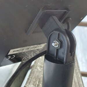 May include: A black plastic mount with a screw for attaching a solar panel to a pole.