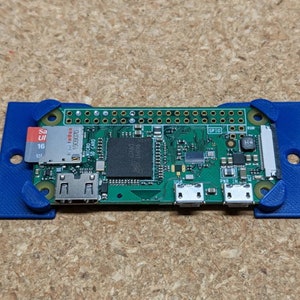May include: A green circuit board with a blue plastic case. The board has a micro SD card slot, a micro USB port, and a HDMI port. The text "GPIO" is visible on the board.