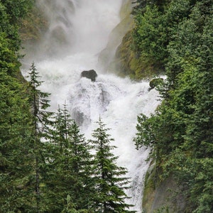 Glacial waterfall in Alaska, powerful summer waterfall photo