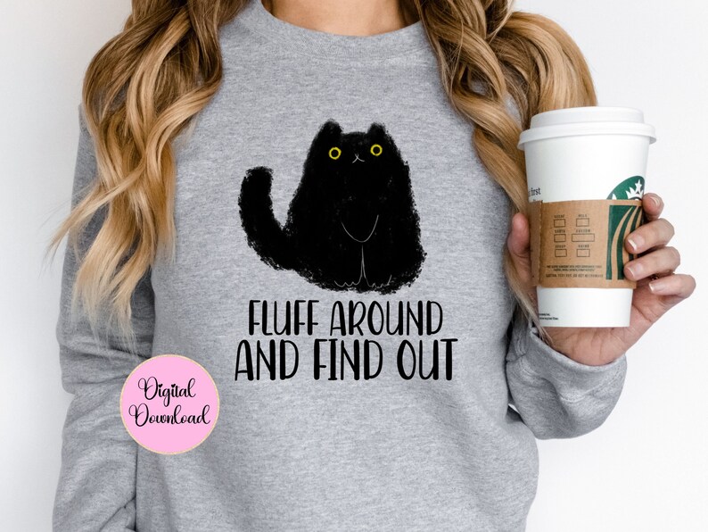 May include: Gray sweatshirt with a black cat illustration and the text "Fluff around and find out".