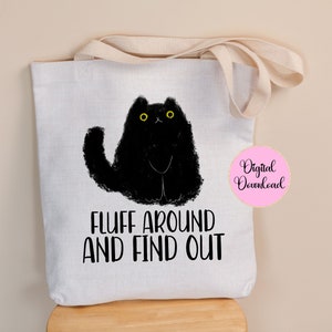 May include: White tote bag with black cat illustration and the text "Fluff around and find out".