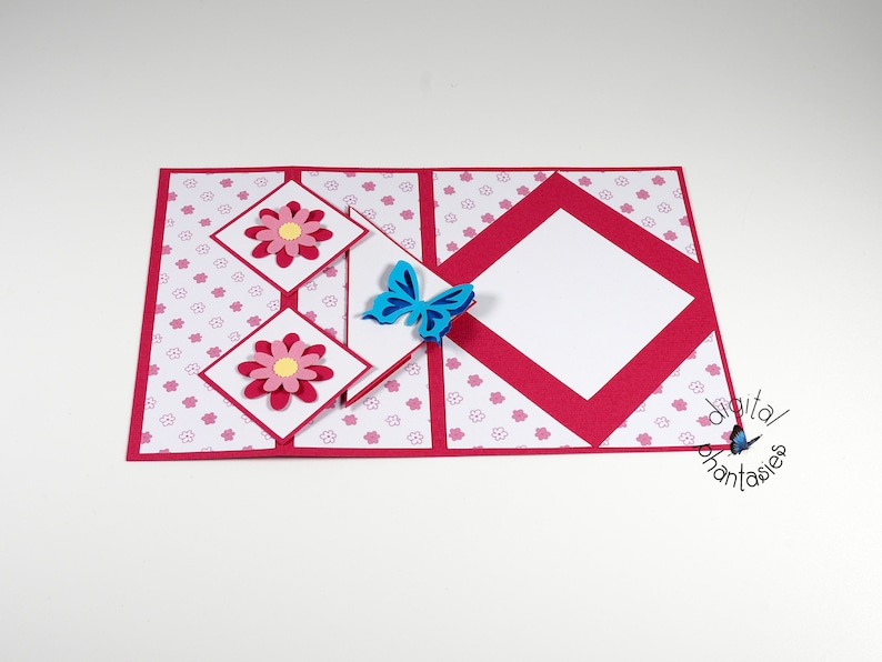 May include: A red and white card with a pop-up design featuring pink flowers and a blue butterfly. The card has a white background with a pink floral pattern.