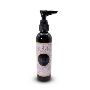 May include: A black bottle with a pump dispenser containing a body serum. The label is white with gold trim and pink floral designs. The text on the label reads "Hydro Primer Body Serum" and "Simple Luxe Skincare".