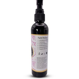 May include: A black bottle with a pump dispenser containing A'selle Botanics pH Balanced Hydrating Serum. The bottle label features a floral design and lists ingredients including organic aloe vera, kosher glycerin, and hyaluronic acid.