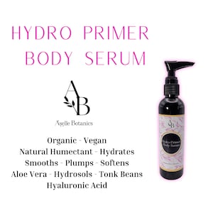 May include: A clear bottle of Hydro Primer Body Serum by Aşelle Botanics. The bottle has a black pump top and a black label with white text. The label reads "Hydro Primer Body Serum" and "Aşelle Botanics". The bottle is sitting on a white background. The text below the bottle reads "Organic - Vegan, Natural Humectant - Hydrates, Smooths - Plumps - Softens, Aloe Vera - Hydrosols - Tonk Beans, Hyaluronic Acid."