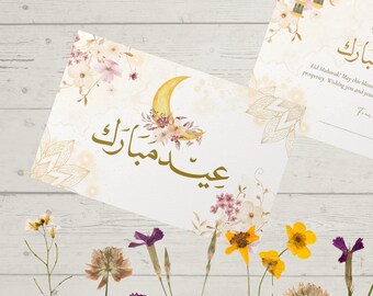 Puede incluir: Dos tarjetas de felicitación blancas con letras doradas y diseños florales. El texto en las tarjetas dice "¡Eid Mubarak! Que este día bendito te traiga alegría, paz y prosperidad. ¡Deseando a ti y a tu familia una maravillosa celebración!" y "¡Eid Mubarak!"