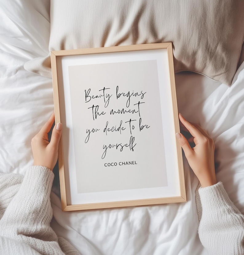 May include: A framed print with a quote by Coco Chanel that reads "Beauty begins the moment you decide to be yourself".