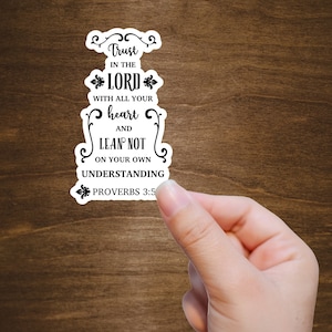 May include: White sticker with black text that reads "Trust in the Lord with all your heart and lean not on your own understanding Proverbs 3:5".