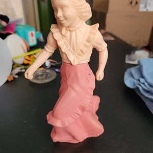 Vintage 1970s perfume bottles have a pink girl and a boy with raincoat #167