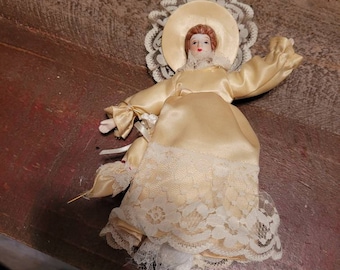 1980s porcelain doll yellow dress