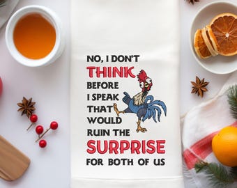 May include: White kitchen towel with the text "NO, I DON'T THINK BEFORE I SPEAK THAT WOULD RUIN THE SURPRISE FOR BOTH OF US" and a cartoon rooster. The rooster is blue, red, and black.