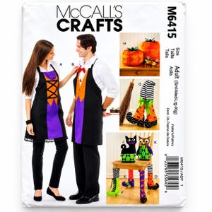 May include: McCall's Crafts M6415 sewing pattern envelope featuring instructions for adult aprons, fabric pumpkins, decorative witch boots, and stuffed cat and owl figures. The cover displays finished projects in black, orange, purple, and green.