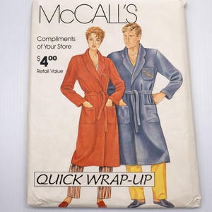 May include: A vintage McCall's sewing pattern envelope with illustrations of a woman in a rust-coloured robe and a man in a blue robe. The text on the envelope includes "McCall's", "Quick Wrap-Up", and "Compliments of Your Store".