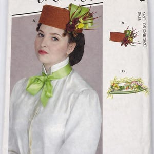 May include: A vintage sewing pattern from McCall's featuring a woman wearing a brown hat with floral accents and a green ribbon. The pattern is labeled M8124 and designed by Angela Clayton.