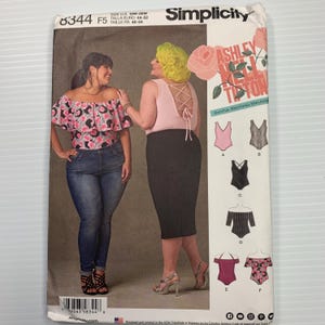 May include: Simplicity sewing pattern 8344 featuring Ashley Nell Tipton designs. The pattern includes options for tops and a bodysuit. The cover shows two women modeling the garments. The pattern size is 18W-26W.
