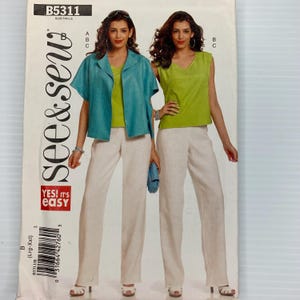 May include: A sewing pattern titled "See & Sew" B5311. The pattern features two women modeling outfits. One outfit includes a teal jacket, a lime green top, and white pants. The other outfit includes a lime green top and white pants. The text "YES! IT'S EASY" is also visible.