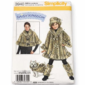 May include: Simplicity sewing pattern with a leopard print coat, hat, and leg warmers for children, and a matching outfit for a dog. The pattern includes the text "DAISY KINGDOM" and size information.