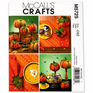 May include: McCall's Crafts M5725 sewing pattern envelope featuring illustrations of fabric pumpkins, decorative leaf napkin rings, and themed cupcakes. The cover displays various finished craft projects in orange, green, and yellow tones with text labels A, B, C, and D.