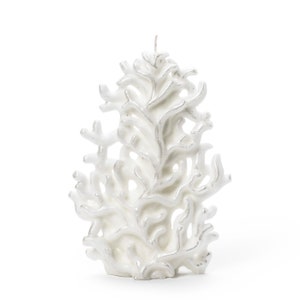 May include: White coral candle with a silver shimmer finish. The candle is shaped like a coral reef and has a delicate, intricate design.
