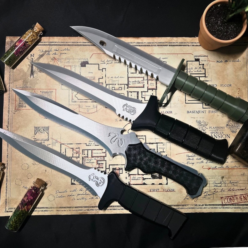 May include: Five different knives with black and silver handles, laid out on a map with the words "Basement First", "First Floor", and "Planning Spencer Mansion".