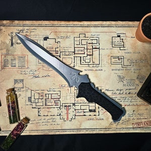 May include: A silver knife with a black handle lies on a vintage map with a floor plan of a mansion. The map is labeled "Planning of Spencer Mansion".