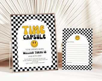 May include: A black and white chequered time capsule sign with a yellow smiley face and the text "TIME CAPSULE" and "TO BE OPENED WHEN WILLIAM TURNS 18 AUG 26TH 2042".  A smaller black and white chequered card with a yellow smiley face and the text "Dear William, With love" is also shown.