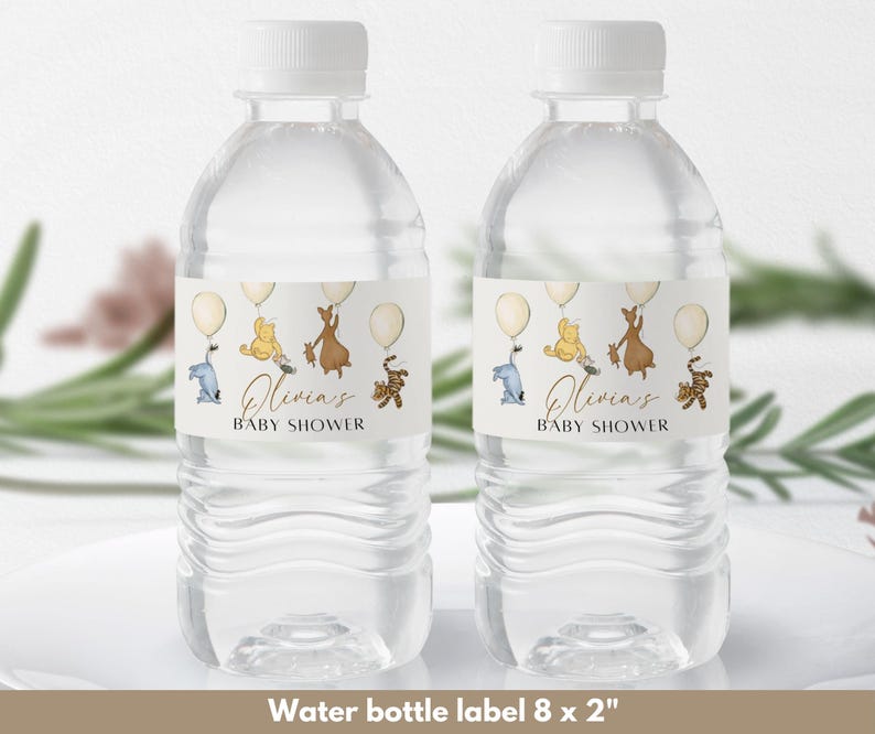 May include: Two clear plastic water bottles with labels featuring Winnie the Pooh characters. The labels are white with brown text that reads "Olivia's Baby Shower". The characters are flying with balloons.