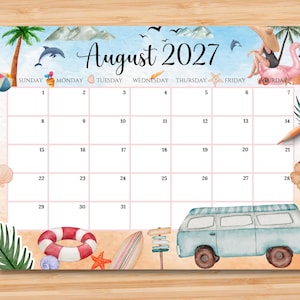 May include: A monthly calendar page for August 2027 featuring a watercolor beach theme. The design includes a blue sky, mountains, a dolphin, a person on a pink flamingo float, a red and white life preserver, a surfboard, and a light blue van.