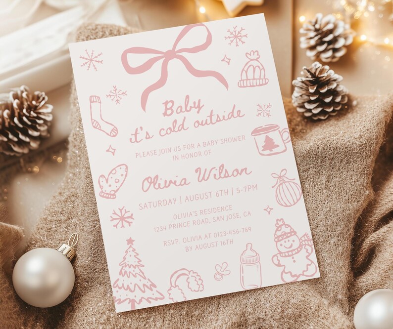 May include: A light pink baby shower invitation with the text "Baby it's cold outside." The invitation includes illustrations of winter-themed items like snowflakes, mittens, and a snowman. The details include the date, time, and location.