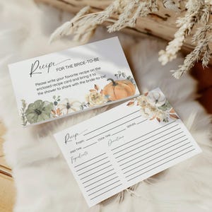 May include: Two white recipe cards with floral and pumpkin illustrations. The top card reads "Recipe FOR THE BRIDE-TO-BE" with instructions. The bottom card has lines for ingredients, prep time, cook time, and directions.