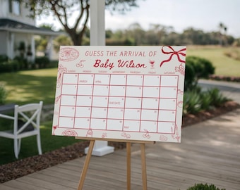 May include: A white sign on a wooden easel with the text "GUESS THE ARRIVAL OF Baby Wilson" in red. The sign has a calendar grid with dates and decorative food illustrations. A red bow is at the top right.