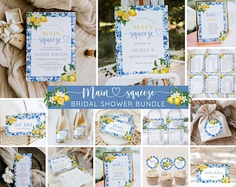 May include: A selection of bridal shower stationery featuring a blue and white floral and lemon design. The set includes invitations, signage, table cards, and cupcake toppers. The text "Main Squeeze" is a prominent feature.