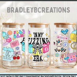 May include: Three clear glass tumblers with bamboo lids, each decorated with colorful graphics. One features a "Fuzzy Candy" design, another says "In My Fizzing Era," and the third has a unicorn and "OG Earrings" text. The tumblers are 16oz.
