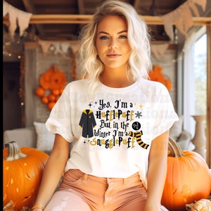 May include: White t-shirt with a graphic print of a black Hogwarts robe and the text "Yes, I'm a Hufflepuff but in the winter I'm a Snugglepuff".
