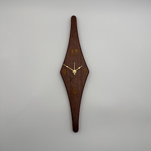 May include: A set of three ceramic mugs with a speckled, matte finish. The mugs are in shades of cream, light gray, and dark gray. Each mug has a simple, minimalist design, perfect for coffee or tea.