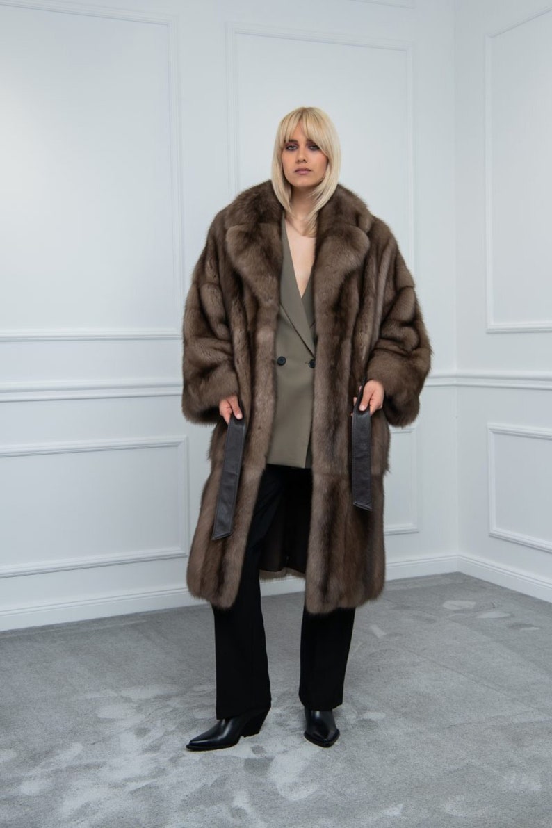 Platinum Sable Relaxed Fit Fur Coat Front. A luxurious sable fur coat with side pockets and leather belt. It has a regular fit and is produced in Greece