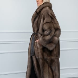 Platinum Sable Relaxed Fit Fur Coat Side. A luxurious sable fur jacket with side pockets and leather belt. It has a regular fit and is produced in Greece