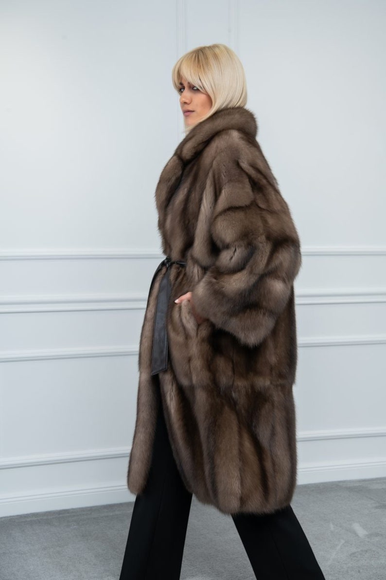 Platinum Sable Relaxed Fit Fur Coat Side. A luxurious sable fur jacket with side pockets and leather belt. It has a regular fit and is produced in Greece