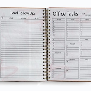 May include: A white planner with a marble pattern. The left page is labelled "Lead Follow Ups" with columns for name, contact, and notes. The right page is labelled "Office Tasks" with sections for schedule, to do, calls, projects, email, meetings, and notes.