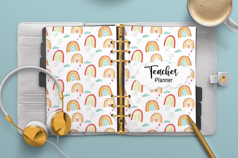 May include: A white teacher planner with a rainbow and heart pattern. The cover says "Teacher Planner" in black text.