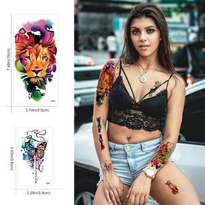 May include: Three temporary tattoo sheets with colorful designs. The first sheet features a lion's head with watercolor-like colors. The second sheet features a butterfly with watercolor-like colors. The third sheet features a lion with watercolor-like colors.