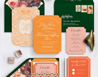 May include: A wedding stationery suite featuring orange and pink cards with white text, dark green envelopes with floral liners, and a small ring box. The set includes an invitation, RSVP card, and details cards with ornate borders and formal typography.