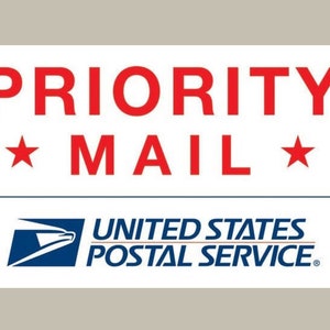 May include: A white label with red text that reads "PRIORITY MAIL" with a red star on either side of the word "MAIL". Below the text is a blue and white United States Postal Service logo.