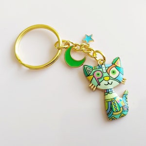 Eigenzinnige kat-sleutelhanger: steampunk-patchwork, ster-maan-bedels