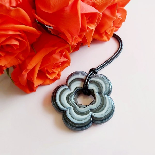 Large black flower pendant. Marbled glass uniquely patterned abstract daisy bead on black cord necklace. Swirly black & white flower power.