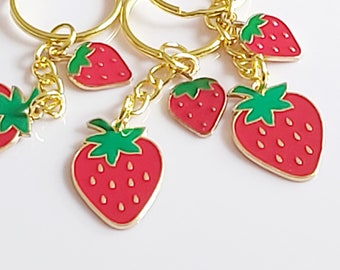 Simply strawberry keyring. Red strawberry keychain. Enamel charms on gold tone split keychain. Double strawberry fruit bag accessory.