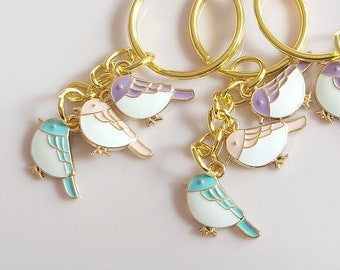 Little bird keyring. Small sparrows in blue, purple and pink on a gold tone keychain. Delicate, sweet little blue bird gift.