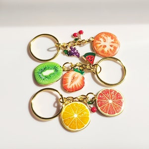 Fruit salad keyring. Strawberry, watermelon, cherry, kiwi, grapefruit, orange, citrus, grape, tomato enamel charms on gold tone keychain