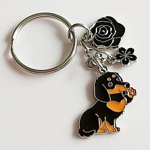 Sausage Dog Keyring and Keychain – Silver Tone Black & Brown Cartoon Dachshund with Raised Paw and flower charms – Dog Lover Gift. Bag Charm