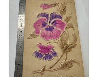 May include: Vintage embossed postcard with a floral design featuring pink and purple pansies with brown stems and leaves. The text "Birthday Greetings" is printed at the bottom of the card.
